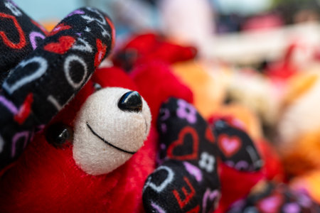 This stock photo shows a close-up of a variety of red teddy bear soft toys. The bears are all different sizes and shapesの写真素材