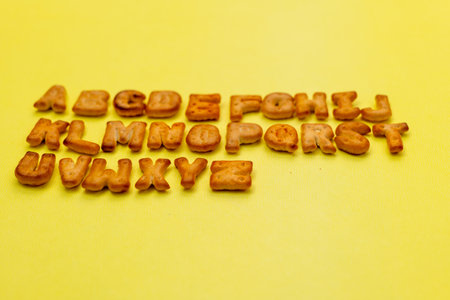 This image is about Abc cookies alphabet yellow background. stock photo lower angle shotの写真素材