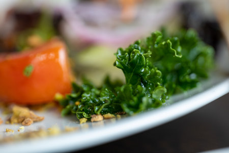 vegetables, small tomato, cabbage and nuts delicious Italian food style dish on white plateの写真素材