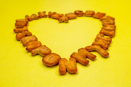 This image is about Abc biscuits alphabet yellow background. stock photo Heart Shapeの写真素材