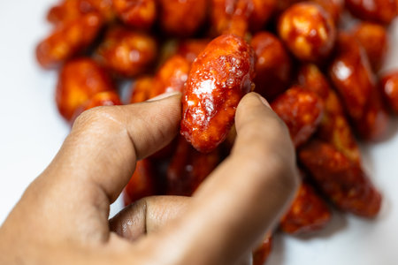 A close-up of milagai mittai, a traditional Indian chilli candy, on a white backgroundの写真素材