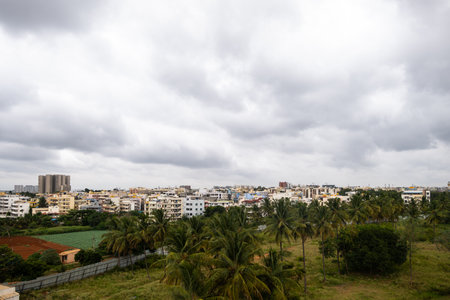 A panoramic view of a large Indian city, with many tall buildings and a vibrant orange sky. The buildings are a mix of traditional Indian architecture and modern skyscrapers.の写真素材