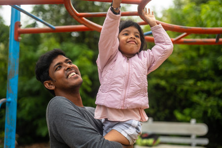 The photo captures the joy of father-daughter bonding and the importance of physical activity. A...