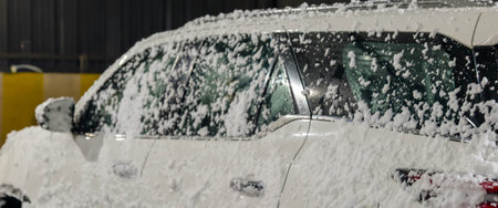Car covered with snow in a winter day. Selective focus.の写真素材