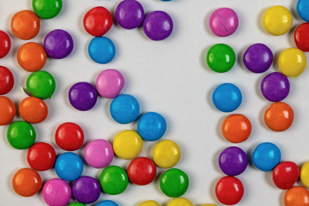 Colorful candies in the form of a circle on a white background.