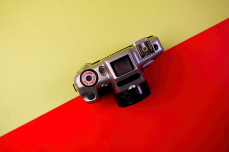 Vintage camera on a red and yellow background. Top view.