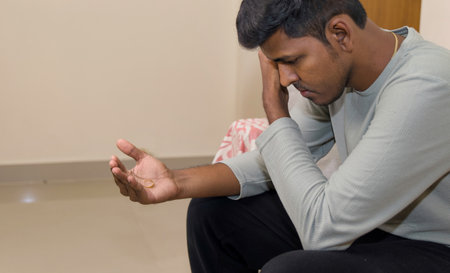 young sad and depressed Indian man looking the ring concept of breakupの写真素材