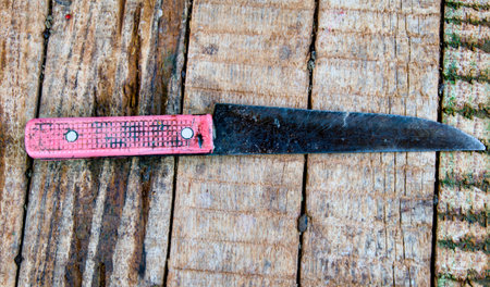 old knife on a wooden background, close-up, top viewの写真素材