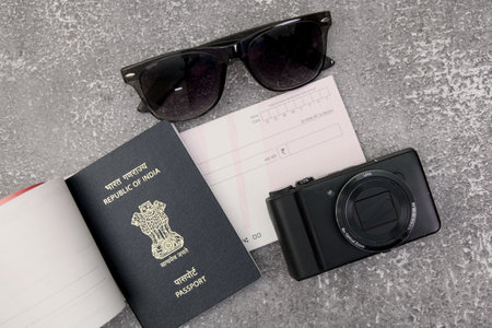 passport, camera, sunglasses and cheque on a gray stone backgroundの写真素材
