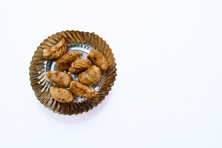 Delicious fried momos served on a pristine white backdrop. Perfect for food-themed designsの写真素材