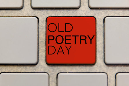 Close-up of a red keyboard key with the words 'Old Poetry Day' written on it symbolizing a special...