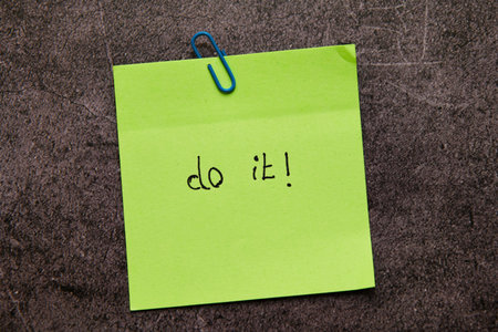 A bright green sticky note with Do it! written on it, clipped to a textured background. A powerful...