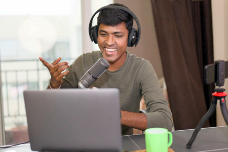 Young man rocking his home studio, recording a podcast or live stream with a smile.