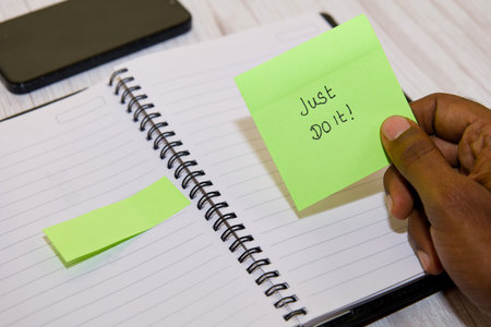 Green reminder note with 'Just Do It' message for motivation and inspiration.の写真素材