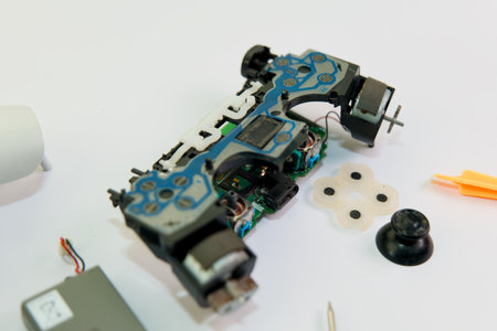 A disassembled game controller lays bare its inner workings, ready for repair or modification.