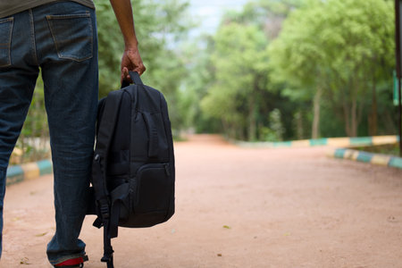 Ready for adventure? Backpack in hand, this traveler sets off down a dusty path towards new experiences.の写真素材