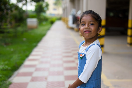 A young Indian girl beams with pride, sporting the Indian flag on her dress.の写真素材