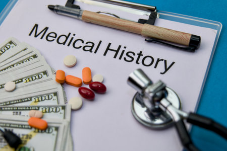 The high cost of healthcare illustrated by money, pills, a stethoscope, and a medical history document.の写真素材