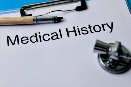Close-up of a medical history form with pen and stethoscope, highlighting the importance of health records.の写真素材