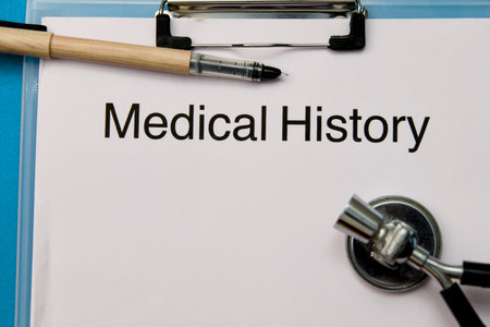 Blank medical history form on clipboard with pen and stethoscope, ready for patient information.の写真素材