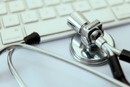 Stethoscope resting on a keyboard, symbolizing the convergence of technology and medicine.の写真素材