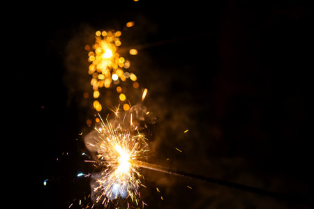 Golden sparks dance in the night, creating a magical ambiance. Perfect for celebrations and festive...