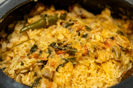 Aromatic rice, tender chicken, and spices cooked to perfection in a traditional clay pot. A flavorful and comforting dish.の写真素材
