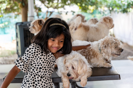 A young girl smiles sweetly, surrounded by her adorable fluffy canine companions. Pure love and...