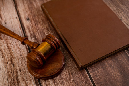 Gavel and law book on wooden table. Justice, legal, court, auction concepts.の写真素材