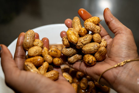 Hands holding freshly washed peanuts, ready for cooking or snacking.  A healthy and delicious treat.