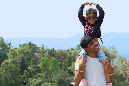 Father and daughter playing together on the mountain. Happy family concept.