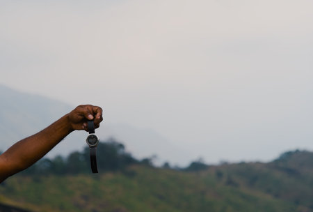 Close up of a hand holding a wrist watchの写真素材