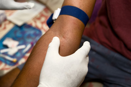 A healthcare professional assists a donor during blood donation, showcasing the process and sterile...