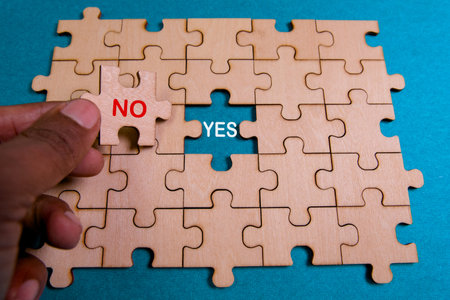 A hand places a 'No' piece in a wooden puzzle with a 'Yes' space. This moment symbolizes...