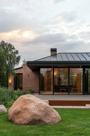 Modern house exterior with terrace and garden at sunset. Nobody insideの素材