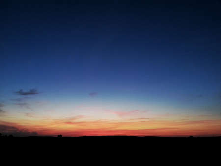 Evening sky. The sun has set and it's on fire for the horizon. Evening lightningの写真素材