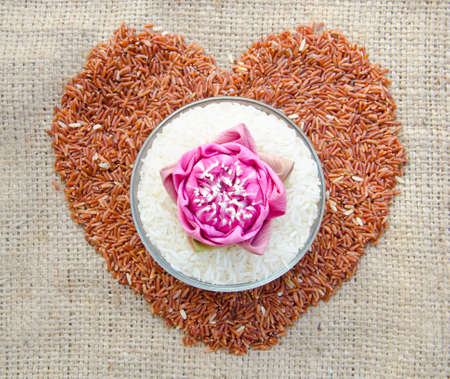 raw Thai jasmine rice and raw brown rice heart shape on sack の写真素材