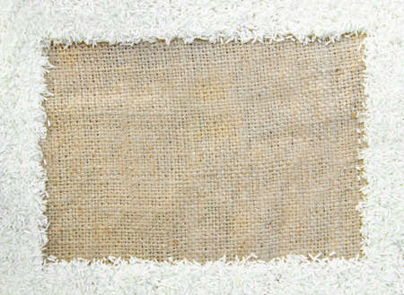 Frame of raw rice on sack backgroundの写真素材