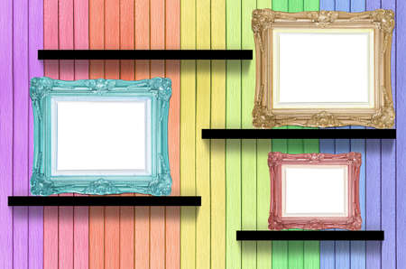 antique frame on colorful wood shelf on wood decorative wallの写真素材