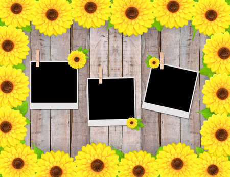 Empty instant photos and sunflowers on old wooden textureの写真素材