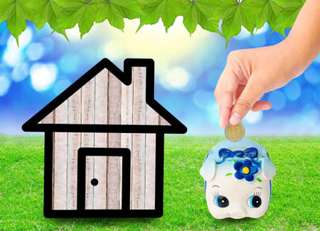 Money Saving with  Piggy bank and home icon. saving money for home concept.の写真素材