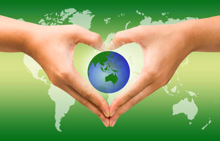 Woman holding globe on her hands over attractive background, Eco concept.