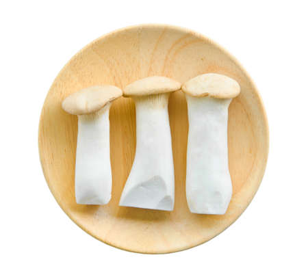 king oyster mushrooms (pleurotus eryngi) in wooden dish on White Backgroundの写真素材