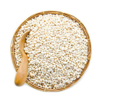 barley grit in weave basket on white background.の写真素材