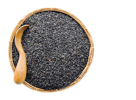 poppy seeds in weave basket on white background.の写真素材