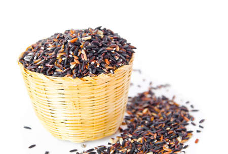 Thai black jasmine rice (Rice berry) in weave basket.の写真素材