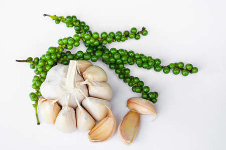 fresh garlic and fresh green peppers on white background.の写真素材