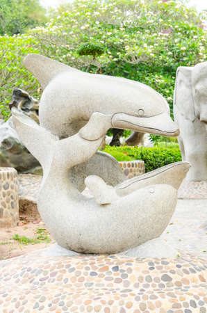 Twin Dolphin statue in gardenの写真素材
