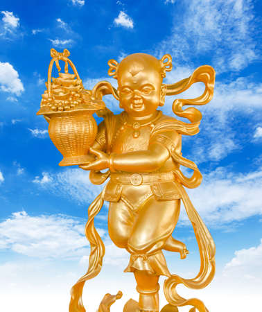 Gold God of Wealth or prosperity (Cai Shen) statue on blue sky background.の写真素材