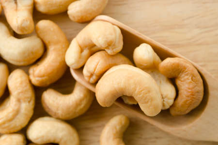 cashew nuts with salt on wooden background.の写真素材